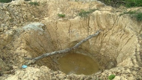 Woman galamsey pit
